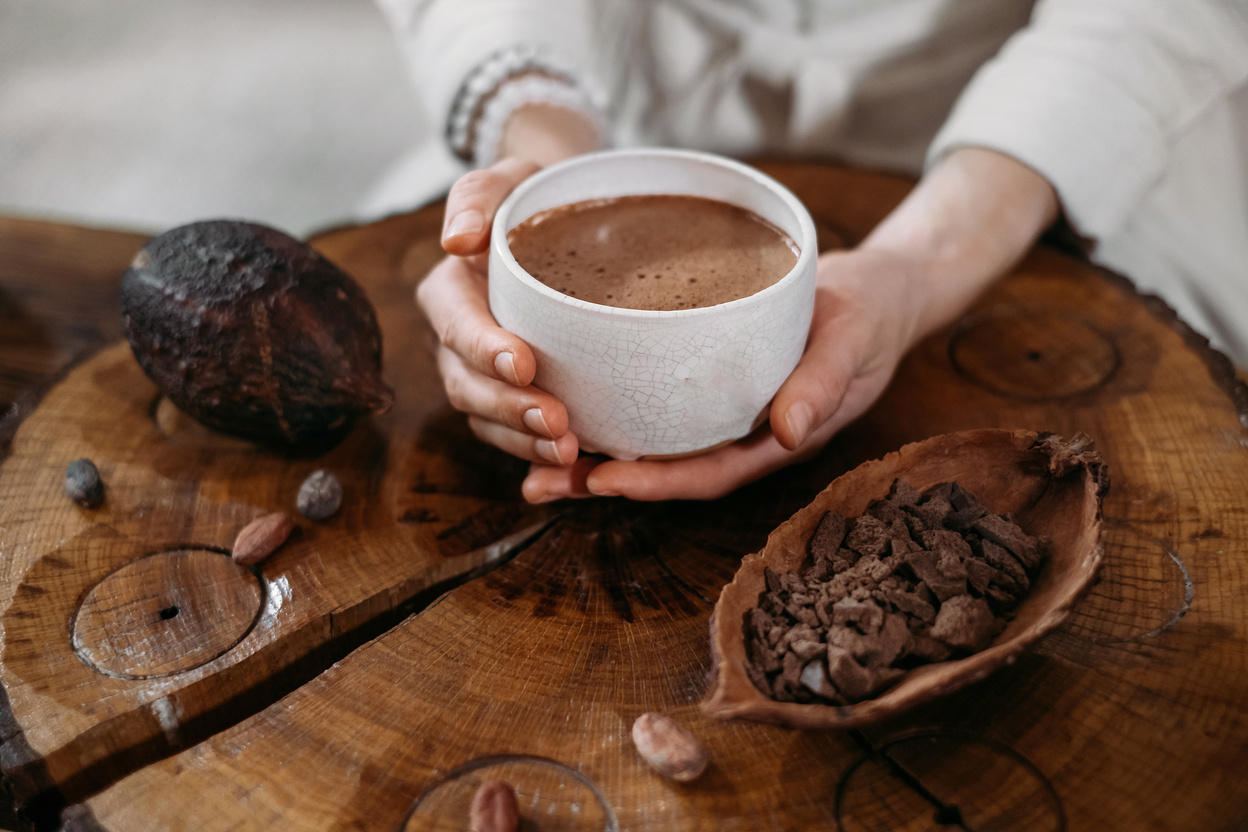 Person Giving Ceremonial Cacao in Cup. Chocolate Drink Top View